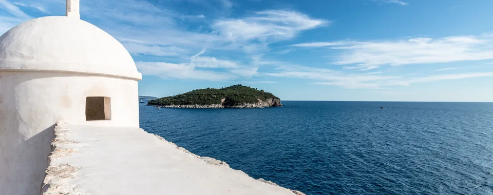 Dubrovnik city walls and Lokrum Island viewed from the Adriatic — private boat tour departure from Dubrovnik