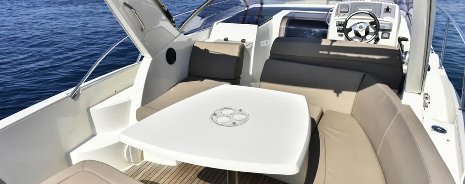 Luxury speedboat interior with spacious seating, dining table, and open cockpit, perfect for Dubrovnik day trips.
