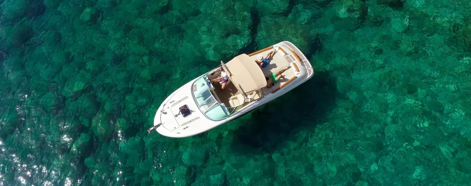 Luxury speedboat anchored in crystal-clear Adriatic Sea near Dubrovnik.