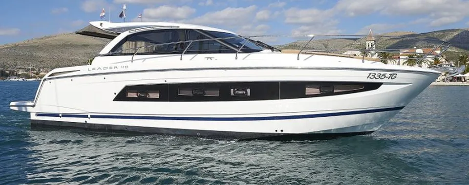 Sleek white Leader 40 luxury yacht cruising the Adriatic Sea near Trogir, offering bespoke private boat tours on the Dalmatian Coast.