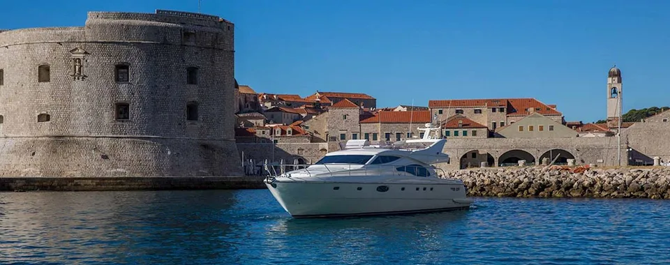 Luxury yacht tour departing from Dubrovnik old town harbor, Croatia.