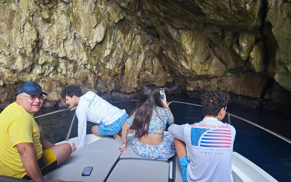 Family explores stunning sea cave near Dubrovnik on a Tendo luxury boat tour. 