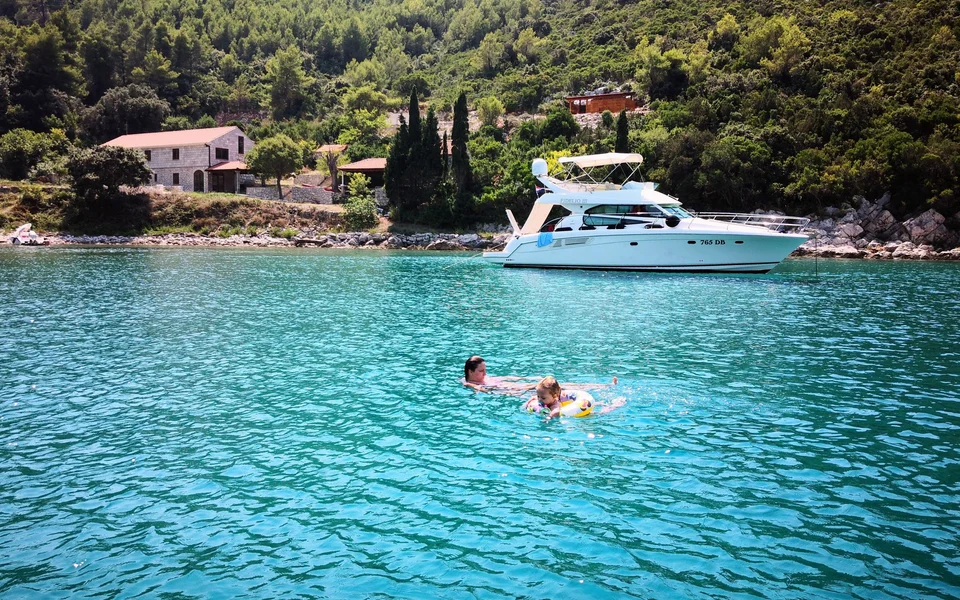 Client enjoying a swim and snorkel in Marculeti Bay, Peljesac Island, during their private yacht charter.