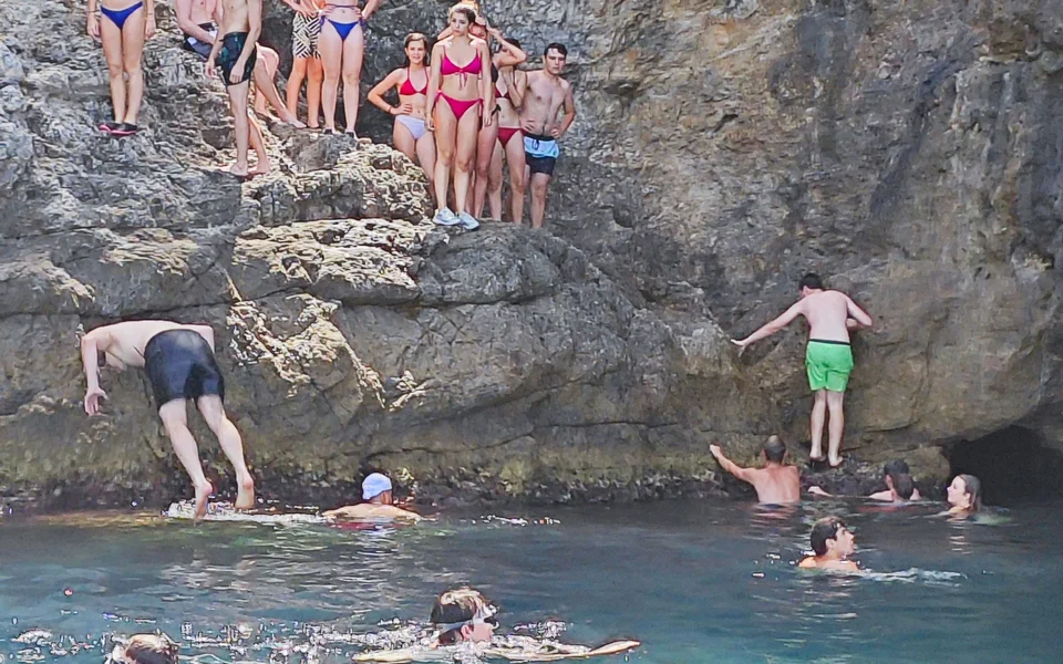 People swimming and snorkeling in front of Blue Cave - Dubrovnik boat tour