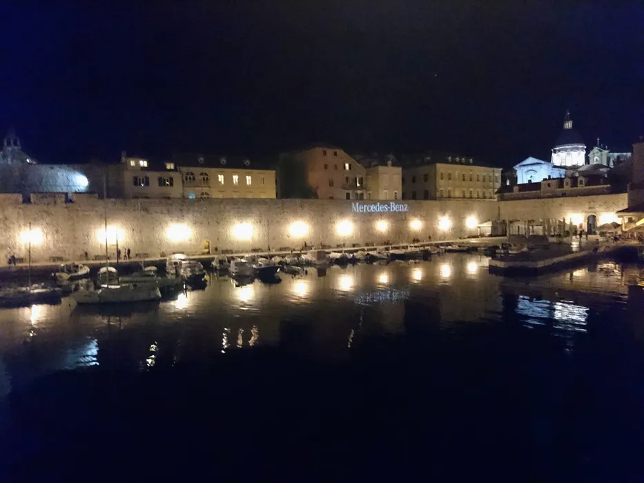 Dubrovnik Old Town harbor at night. Book your Croatian escape with Tendo Luxury Travel.