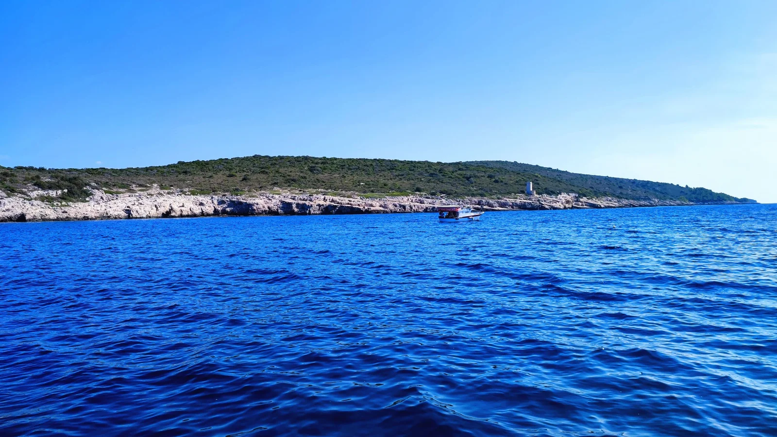 Stunning blue Adriatic waters meet rugged coastline near Hvar, Island Scedro, perfect for unforgettable boat tours and island exploration