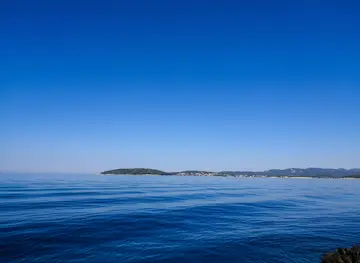 On the way from Dubrovnik to Hvar experience calm blue sea with distant islands on horizon under clear sky