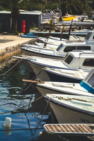 Traditional boats docked in the picturesque Milna harbor on Brač Island, a tranquil stop on luxury yacht charters from Split.