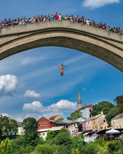 Divers jumping off Stari Most bridge into the Neretva River in Mostar, Bosnia and Herzegovina