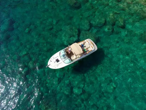 Luxury speedboat anchored in crystal-clear Adriatic Sea near Dubrovnik.