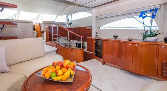 Luxury yacht interior: Elegant cabin with polished wood finishes, comfortable seating, and fresh fruit platter for Dubrovnik boat tours