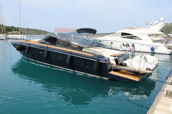 Luxury yacht ITAMA 45 moored in Dubrovnik marina, surrounded by crystal-clear Adriatic waters and lush coastal landscape