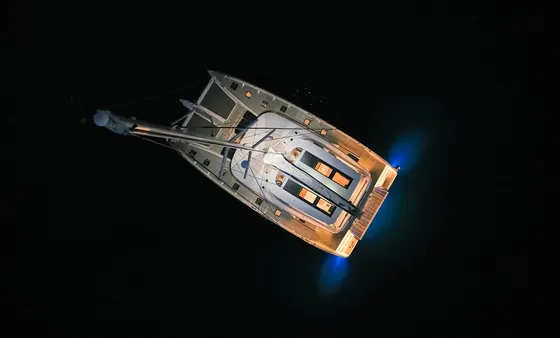 lagoon sixty 5 amada mia yacht at night aerial view blue lights