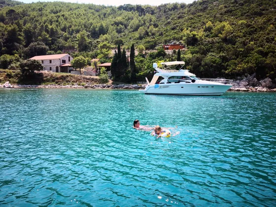 Client enjoying a swim and snorkel in Marculeti Bay, Peljesac Island, during their private yacht charter.