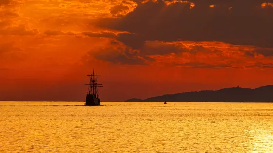 Panoramic sunset view of a Dubrovnik luxury event ship on the Adriatic horizon
