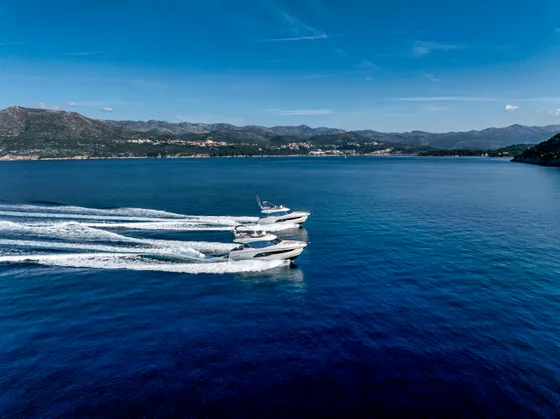 Two luxury yachts cruising on deep blue Adriatic Sea near Dubrovnik, Croatia, perfect for a bespoke charter experience.