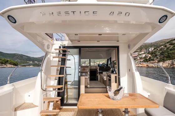 Luxury Prestige 420 yacht stern deck with champagne bucket, overlooking the beautiful Adriatic Sea near Dubrovnik, Croatia.