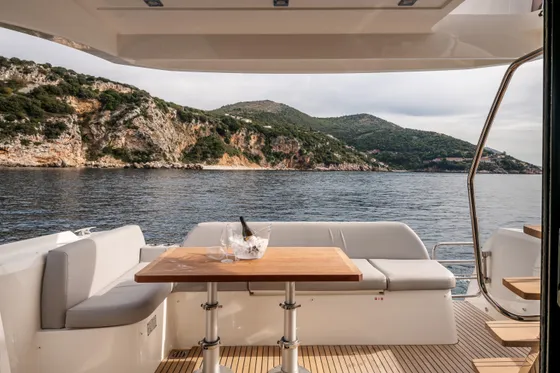 Enjoying champagne on a private luxury yacht charter in Dubrovnik, Croatia, with stunning Adriatic coastal views.