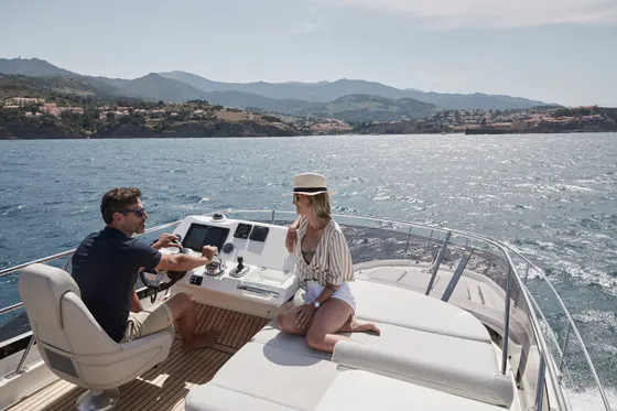 Couple enjoying a luxury yacht charter from Dubrovnik, cruising the scenic Adriatic Sea coastline in Croatia.