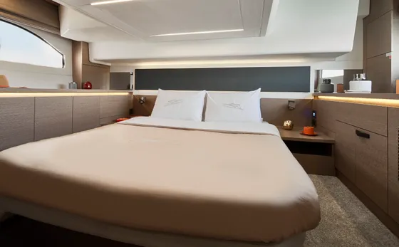 Luxurious master cabin on a Prestige 420 yacht, featuring a comfortable bed, modern decor, and soft lighting for charters in Dubrovnik.