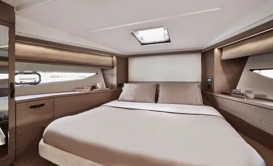Luxury yacht master cabin with queen bed, elegant wood interior, and natural light, perfect for Dubrovnik charters.