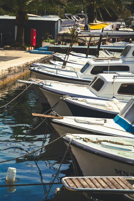 Traditional boats docked in the picturesque Milna harbor on Brač Island, a tranquil stop on luxury yacht charters from Split.