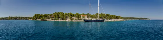 Luxury private sailboat anchored in the turquoise Maslinica Bay, Dalmatian Coast, ideal for tailor-made tours from Split, Croatia.