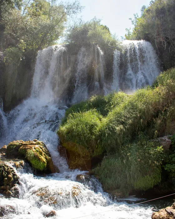 Kravice Waterfalls cascading over travertine cliffs into the Trebižat river pool, Bosnia