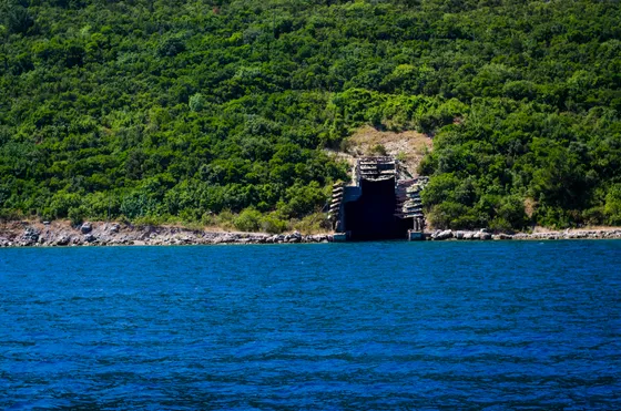 Kotor Old Town and medieval walls climbing the mountainside, seen from the Bay of Kotor at the start of the yacht transfer to Dubrovnik