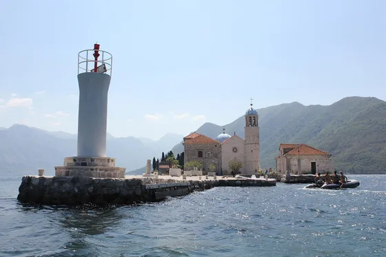 Our Lady of the Rocks church and lighthouse on a man-made islet off Perast in the Bay of Kotor, Montenegro