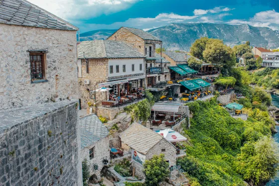 Aerial view of Mostar old town with Stari Most bridge, Neretva river and surrounding mountains