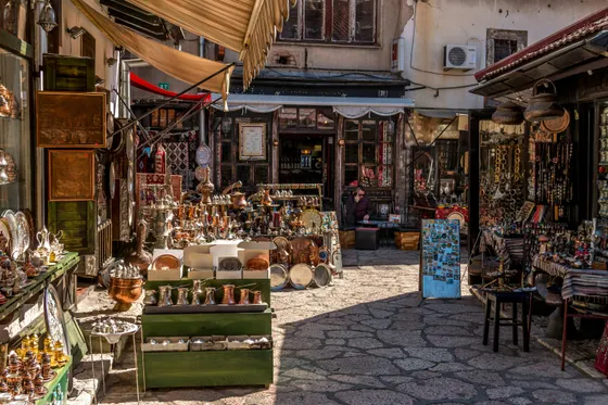 Narrow Ottoman-era market street in Baščaršija old town Sarajevo lined with souvenir and coppersmith stalls, Bosnia
