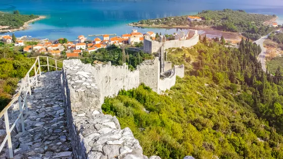 View from atop the Ston walls along the ancient battlements with village rooftops and Mali Ston Bay visible below, Dalmatia, Croatia