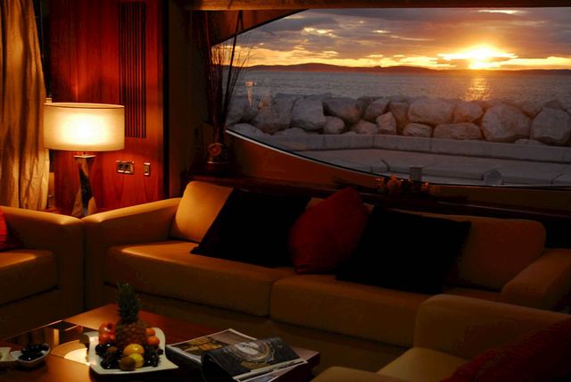 Luxurious yacht interior with comfortable seating and sunset view through window