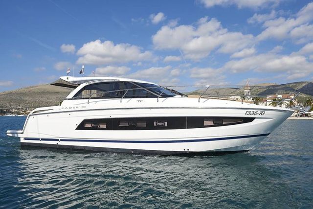 Luxurious yacht cruising along Dubrovnik's coastline, offering stunning views of the Adriatic Sea and nearby mountains.