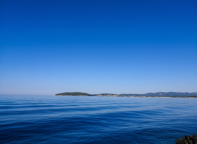 On the way from Dubrovnik to Hvar experience calm blue sea with distant islands on horizon under clear sky