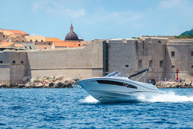 Explore Dubrovnik by boat. Speed boat Jeanneau Cap Camarat 9 Dubrovnik Old Town walls